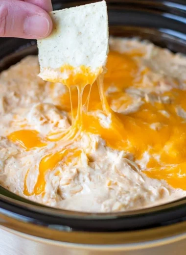 Creamy Maryland crab dip served in a bowl with crackers and garnished with herbs