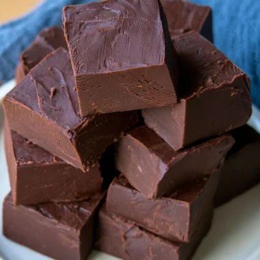 Bowl of easy no fail fudge with chocolate and nuts, ready to serve