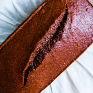 Slice of real gingerbread cake loaf on a plate with festive decorations
