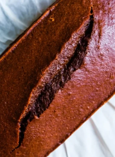 Slice of real gingerbread cake loaf on a plate with festive decorations